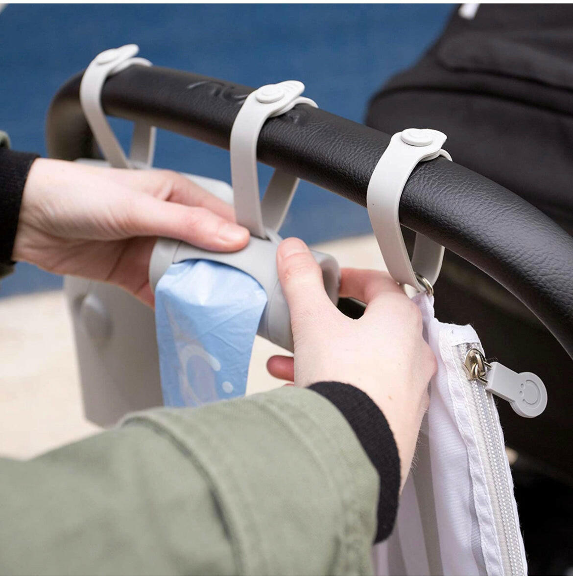 Ubbi Retractable On the Go Bag Dispenser for Baby Travel.
